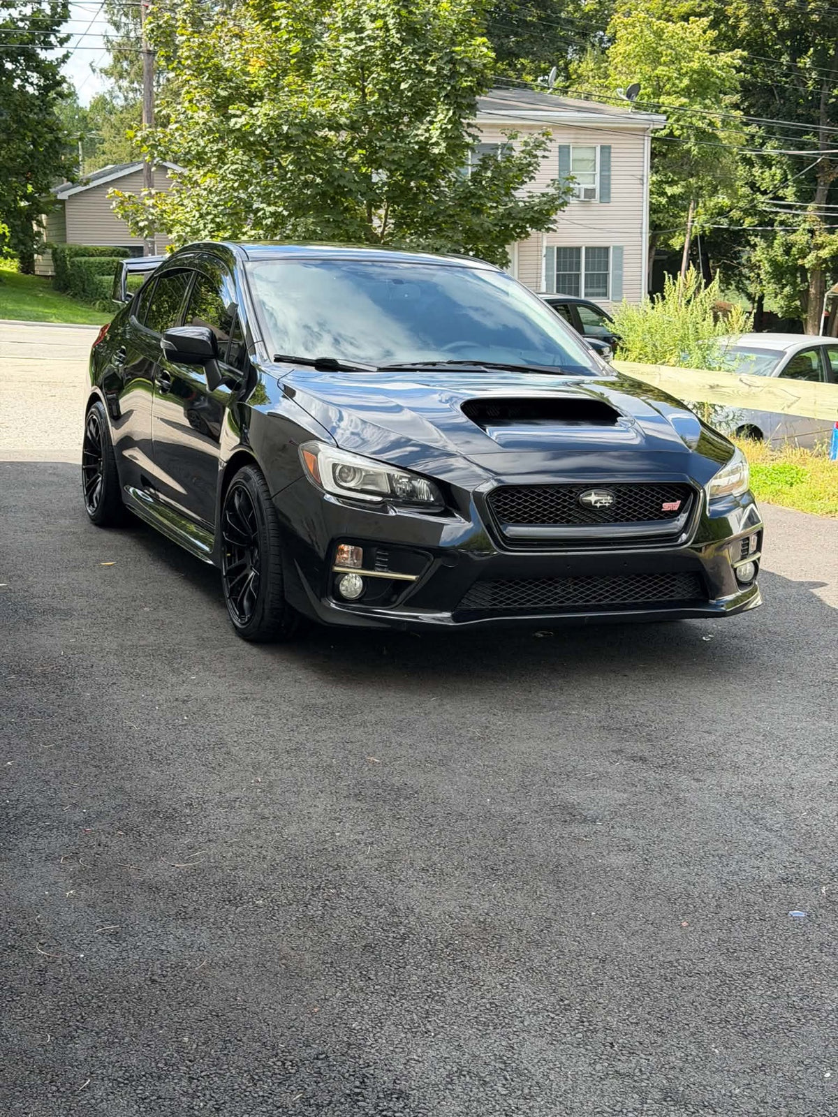 2016 Subaru WRX STI front three-quarter view in black, for sale