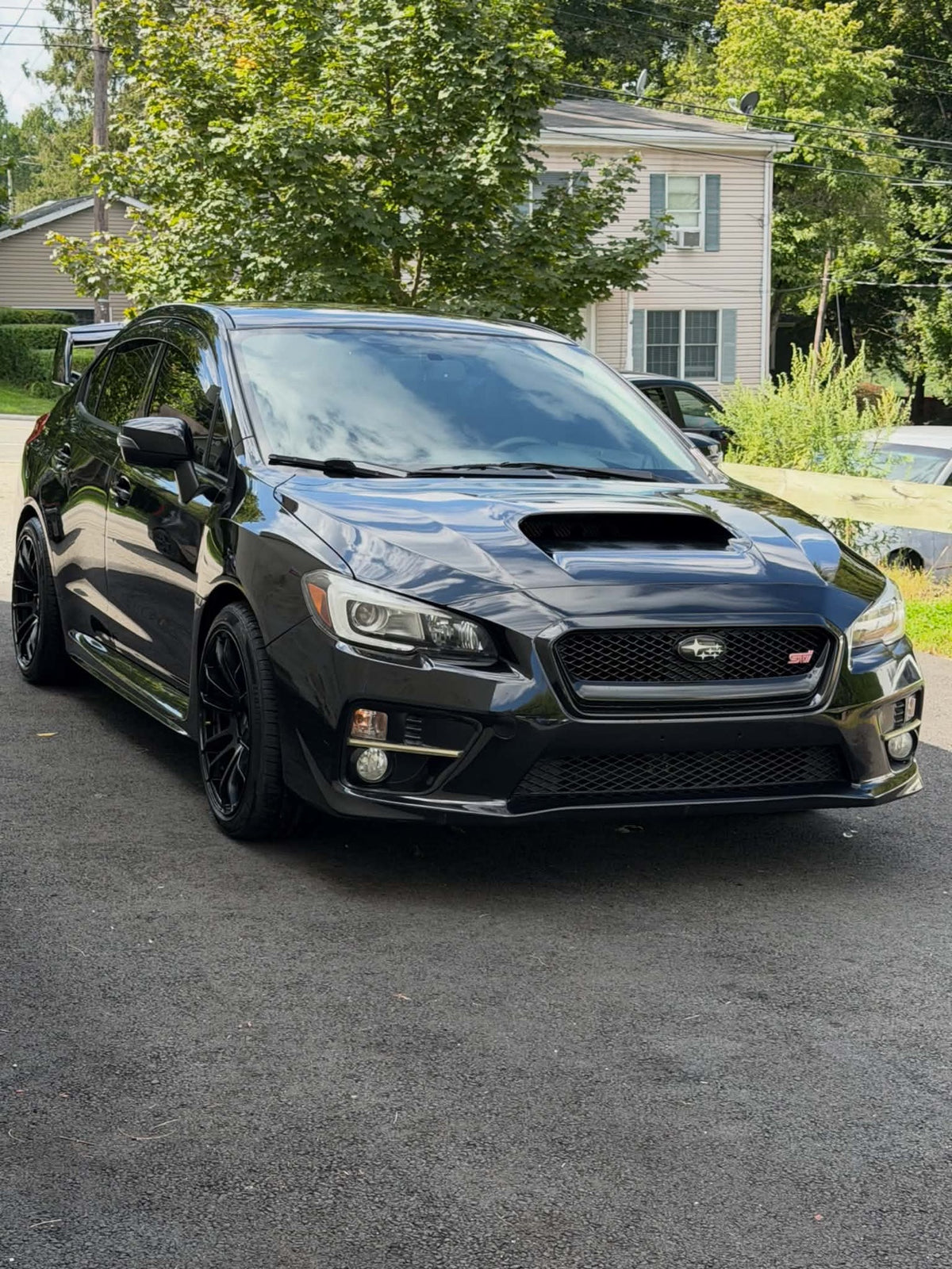 2016 Subaru WRX STI front three-quarter view in black, for sale